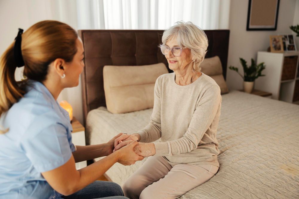 Caregiver holding hands with a senior resident